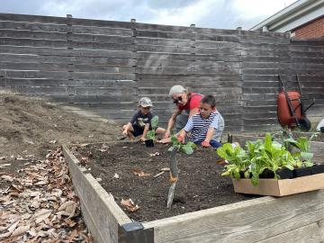 Volunteers cleaning up garden beds